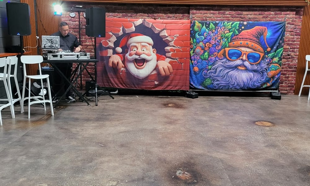 DJ Booth & Festive Decor at Ed’s Place – Function Venue in Dandenong Area DJ performing with festive Santa-themed banners at Ed’s Place event venue near Dandenong